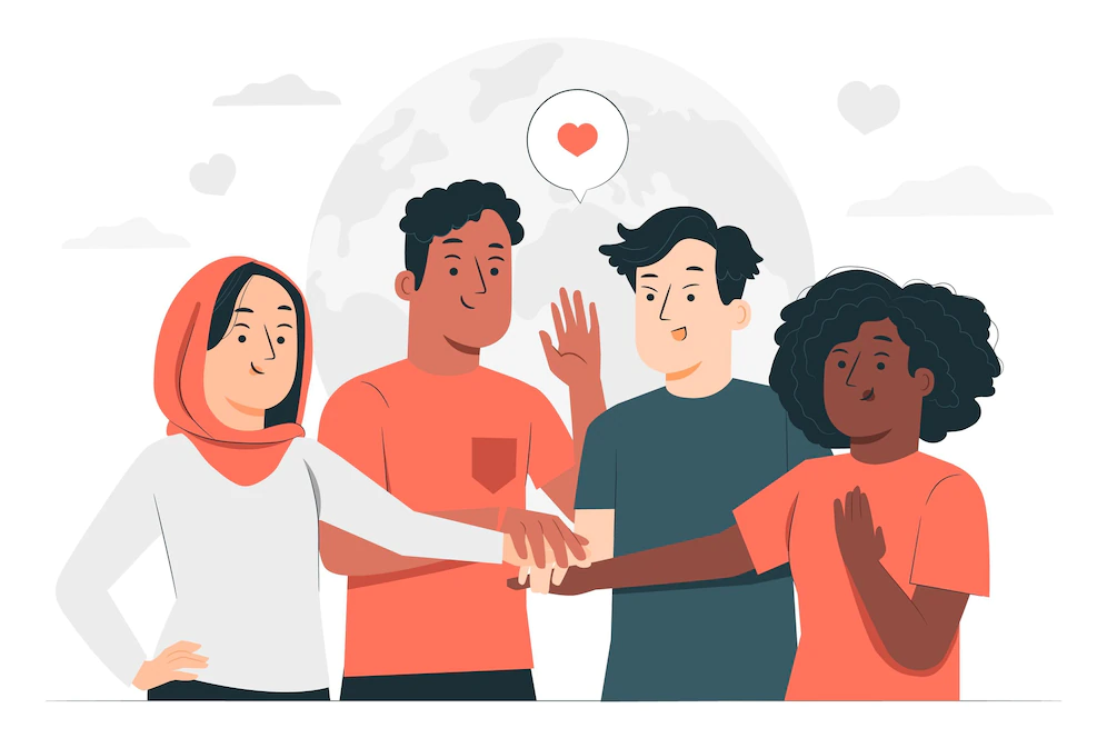 Cuatro personas de diferente género y etnicidad, juntan sus manos y sonríen.